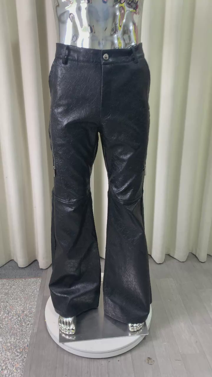 Black Abyss embossed flared pants shown on a rotating mannequin with a close-up of the zip pocket.