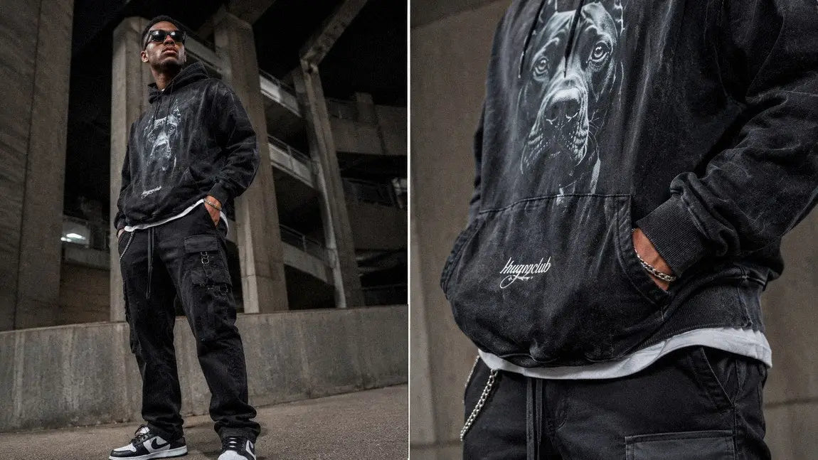 Black streetwear hoodie with a dog graphic worn with cargo pants in a parking garage