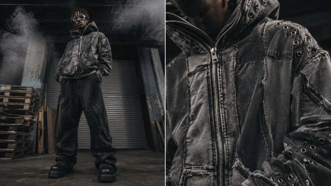 Avant-garde grey streetwear hoodie with grommet detailing in an industrial warehouse