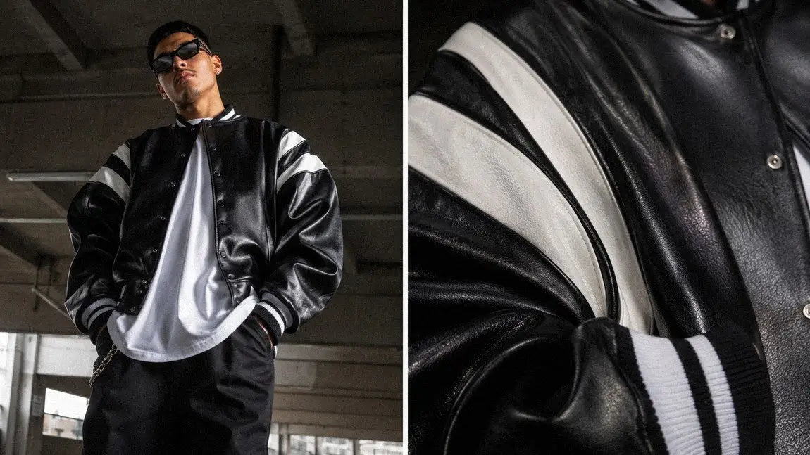 Black and white varsity streetwear jacket layered over a white tee in a parking garage