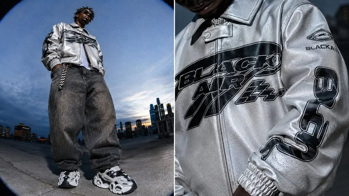 Metallic silver streetwear jacket with bold graphics shown at dusk on a rooftop