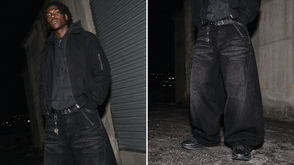 All-black streetwear jeans paired with a bomber jacket for a moody opium-inspired outfit