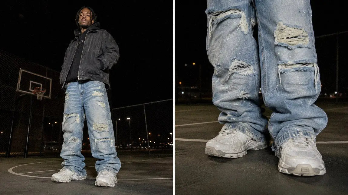 Heavily ripped streetwear jeans paired with chunky white sneakers on a basketball court