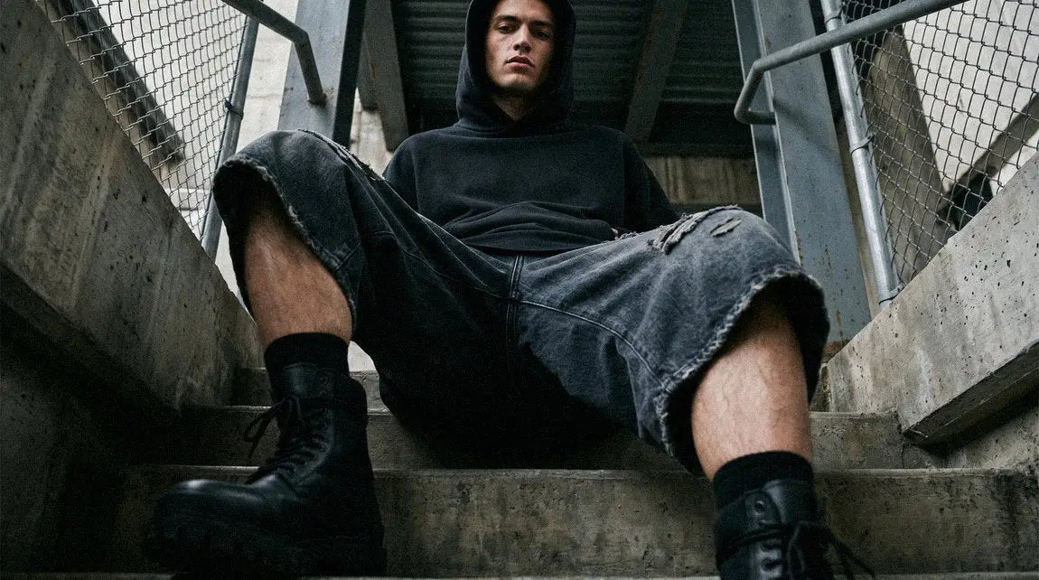 man in streetwear jorts and hoodie
