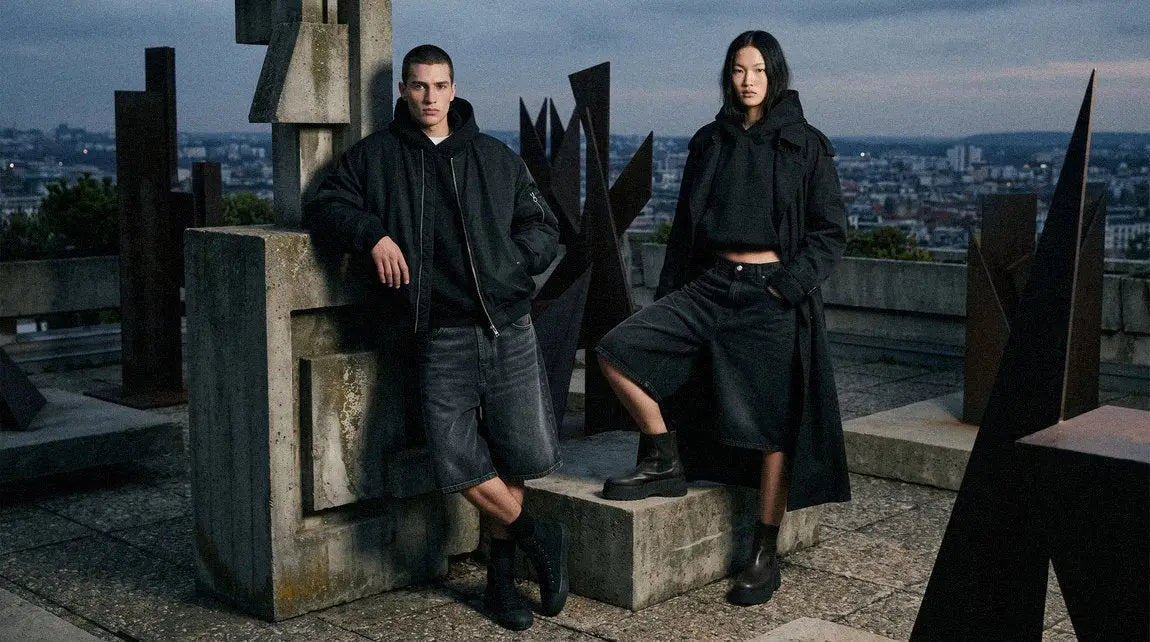 man and a woman in dark streetwear jorts