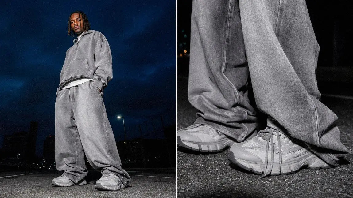 Relaxed grey streetwear pants worn with an oversized hoodie on a city rooftop at night
