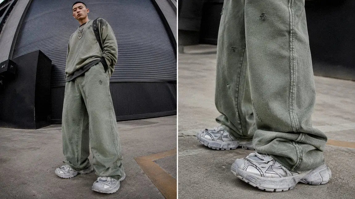 Olive washed streetwear sweatpants layered under an oversized sweater for a faded look