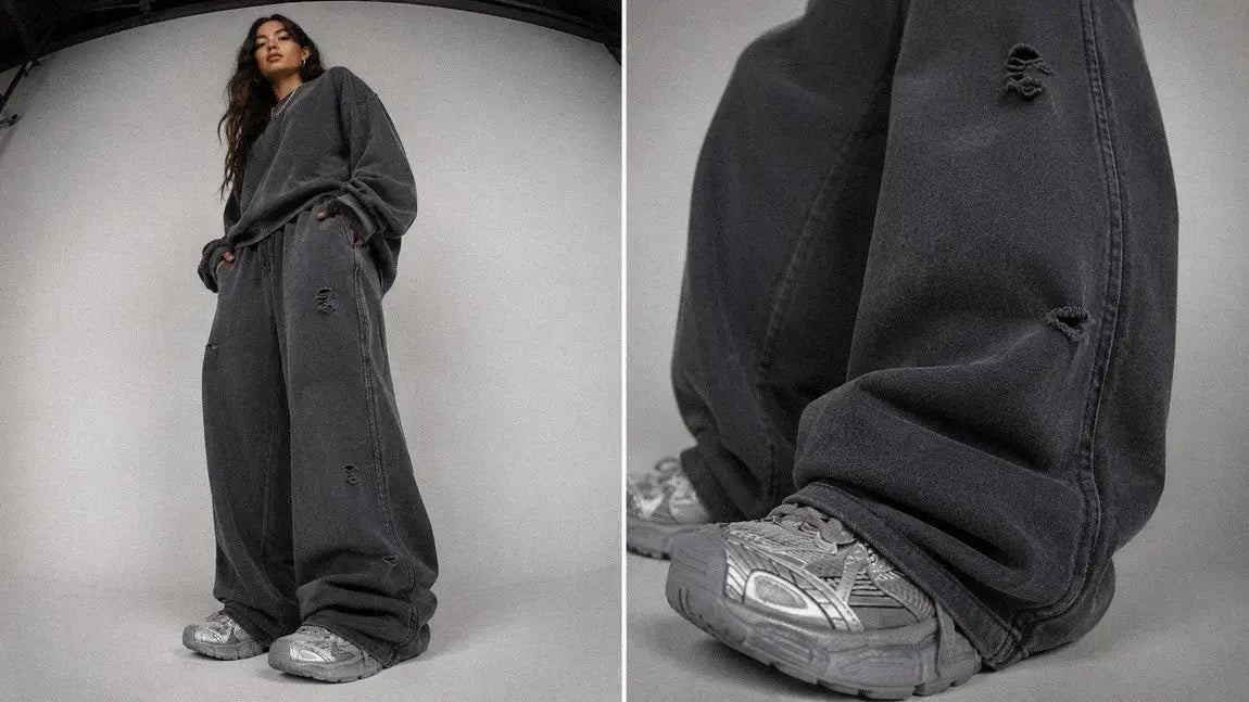 Distressed dark grey streetwear sweatpants styled with an oversized crewneck sweater