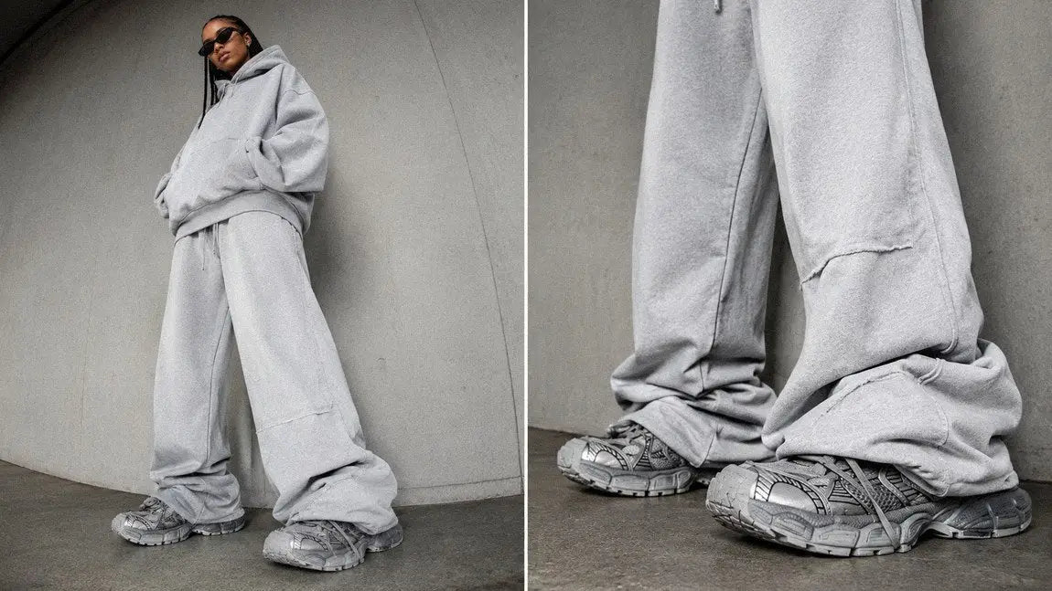 Streetwear sweatpants shown in an oversized wide-leg fit that drapes over chunky sneakers