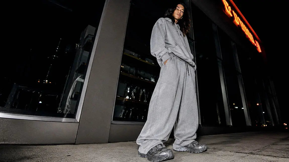Light grey streetwear sweatpants worn for a relaxed look on a night out