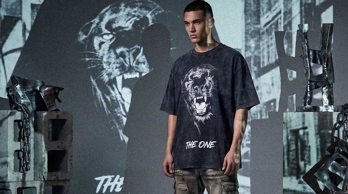 This graphic Streetwear t-shirt features a roaring tiger design inside a dark industrial setting.