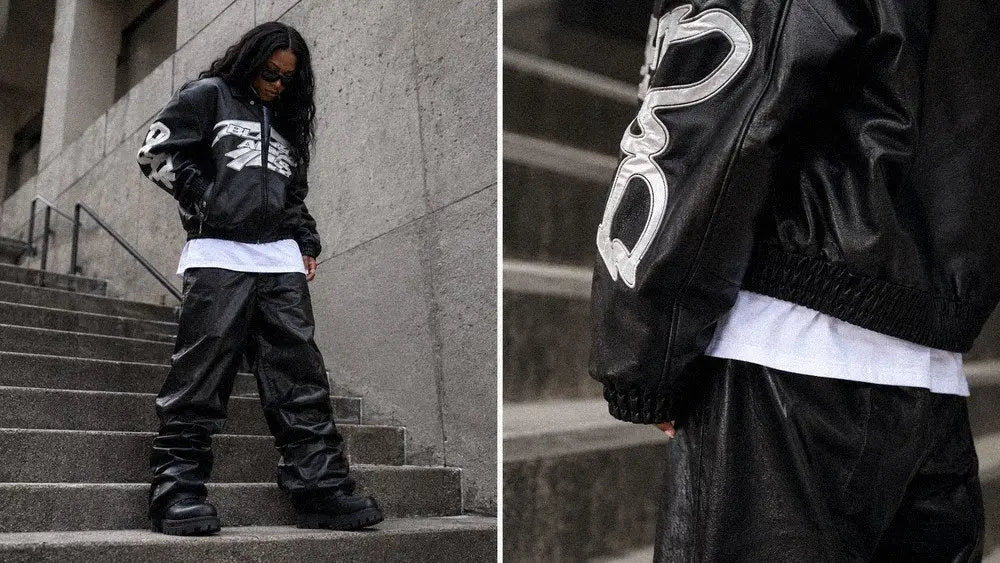 Woman in a black leather varsity jacket and wide trousers styled for women's dark streetwear
