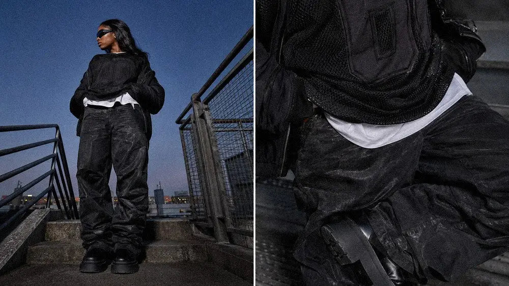 Layered graphic sweater and white tee hem building a dark streetwear wardrobe combination