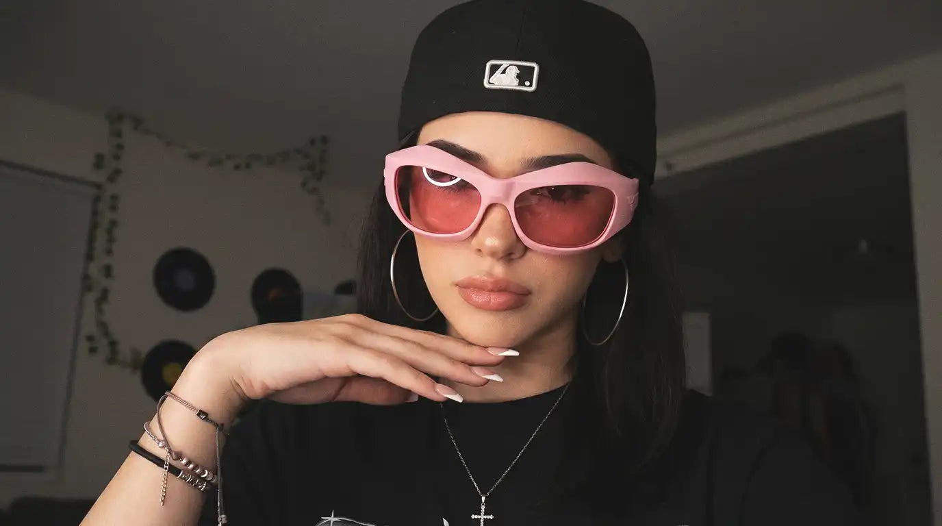 Woman wearing bold streetwear sunglasses with a modern outfit